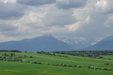 Meadows and High Tatras peaks panorama on background. Presov Region, Slovakia.