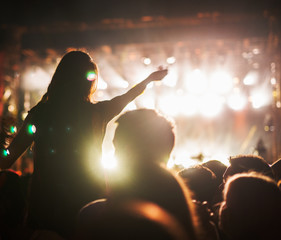 Concert girl at crowd on music festival.
