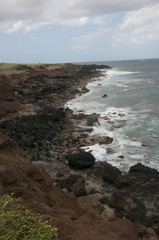 Fototapeta na wymiar Volcanic rock and surf on coastline of Island of Hawaii, USA