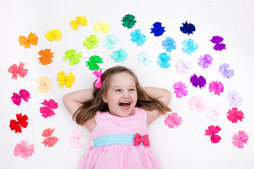 Little girl with colorful bow. Hair accessory