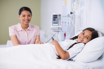 Fototapeta premium Portrait of nurse talking to a girl patient