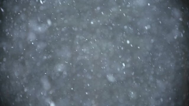 Background of snow fall blowing fast in winter blizzard.