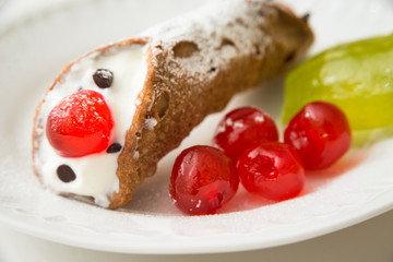 Sicilian Cannolo, traditional dessert stuffed with ricotta cheese, candied fruit and chocolate bits