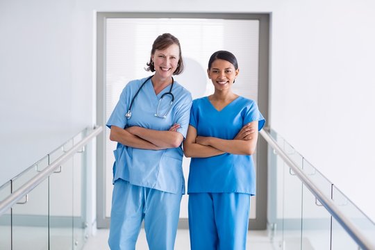 Portrait Of Smiling Nurse And Doctor Standing With Arms Crossed