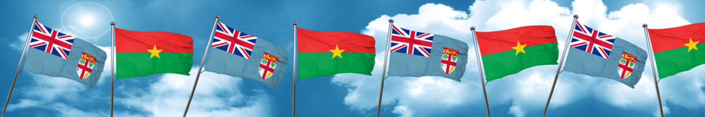 Fiji flag with Burkina Faso flag, 3D rendering