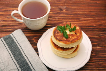Cheese pancakes fried in a pan.