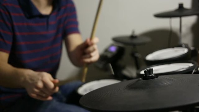 shot of drummer playing at the electronic drums kit