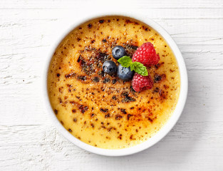 bowl of creme brule on white wooden table