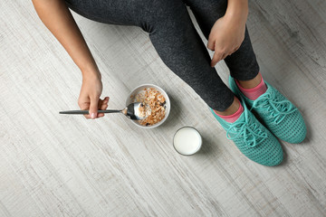 Woman sitting on the floor with healthy breakfast