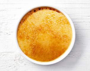 bowl of creme brule on white wooden table
