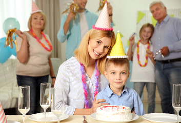 Birthday party. Portrait of mother and little son