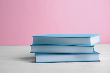 Pile of books on pink background