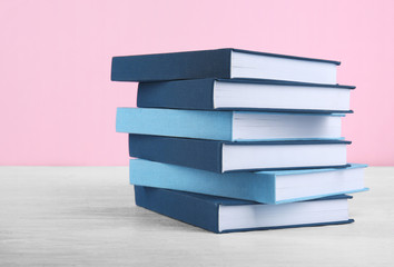 Pile of books on pink background