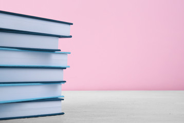 Fototapeta premium Pile of books on pink background