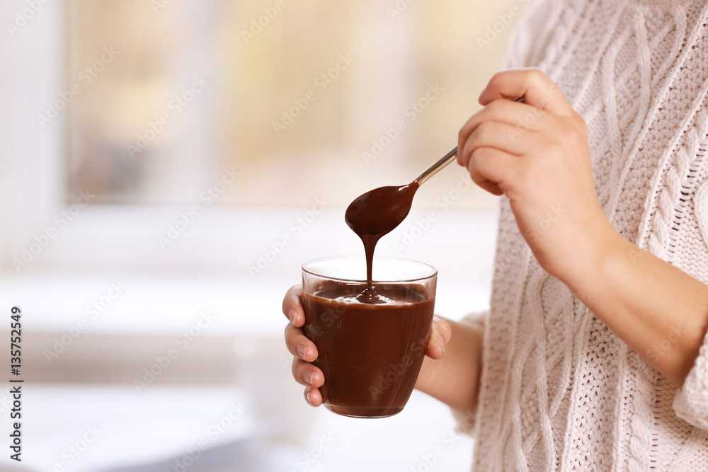 Sticker woman holding glass cup with chocolate mousse, closeup