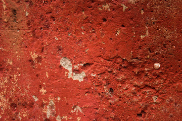 Rusty nails in old red concrete wall