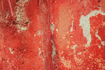 Rusty nails in old red concrete wall
