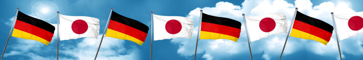 German flag with Japan flag, 3D rendering