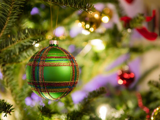 Christmas ball ornament on tree with soft focus decoration in th