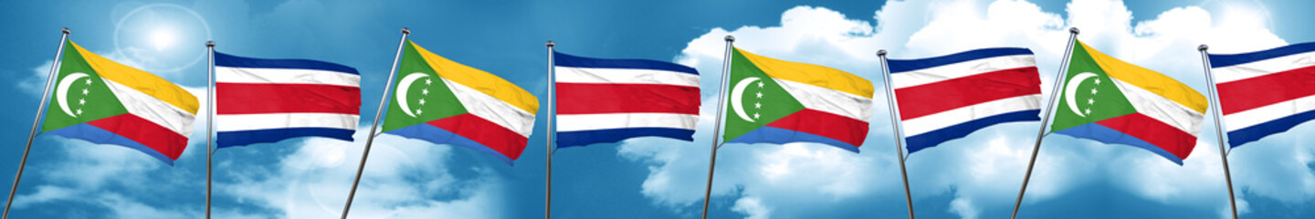 Comoros flag with Costa Rica flag, 3D rendering