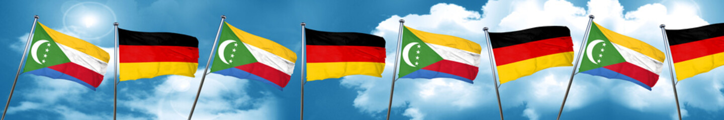Comoros flag with Germany flag, 3D rendering