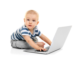 Cute baby boy with laptop on white background