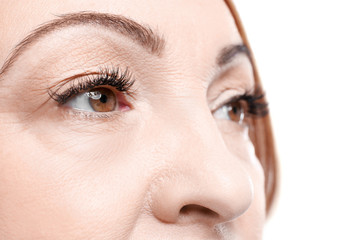 Close up view of senior woman's face on white background