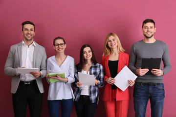Group of people waiting for job interview and standing on colour background