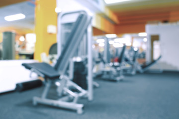 Fototapeta na wymiar Blurred view of gym interior with equipment
