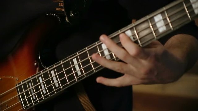 close up shot of bass playing rock n roll.