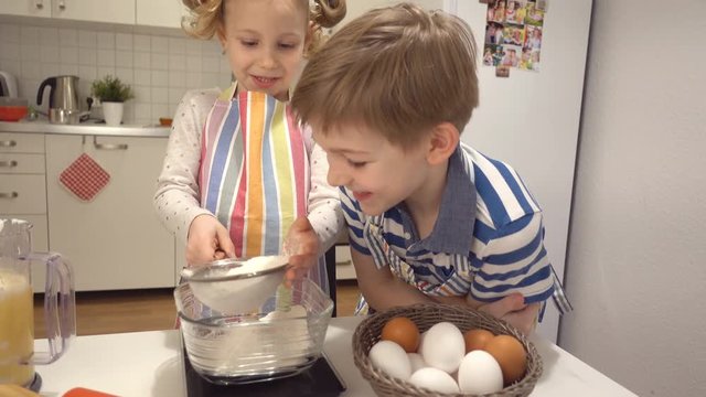 Two happy children playing and having fun during baking Easter sweets