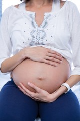 Mid section pregnant woman relaxing in ward