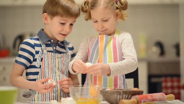 Two happy children playing and having fun during baking Easter sweets