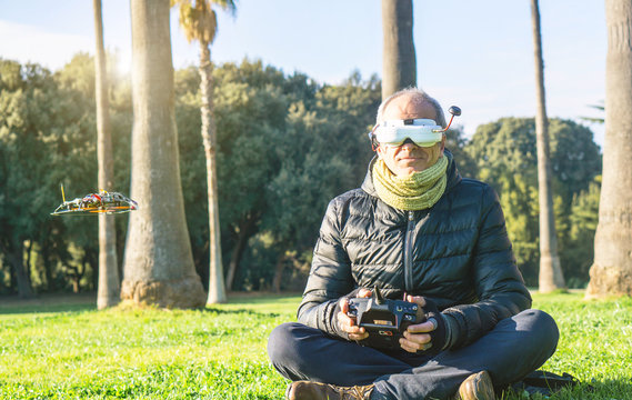 Senior Wearing Virtual Reality Glasses And Flying Drone