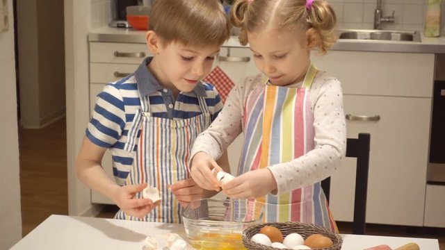 Two happy children playing and having fun during baking Easter sweets