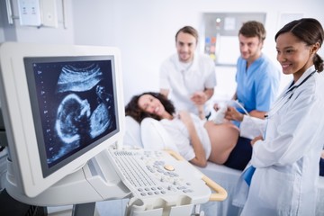 Fototapeta premium Doctor doing ultrasound scan for pregnant woman
