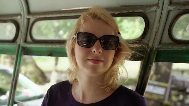 Blonde woman in asian pickup car in sunglasses