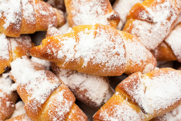 Fresh, delicious, sweet croissants with powdered sugar.