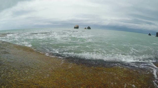 Waves on a rocky beach at day
