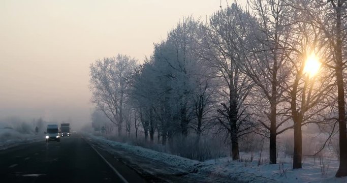 Driving Car Point of View on Winter Morning Foggy Road With Sun at the Sky Car Front Window Windscreen View in Early Morning Foggy Sunrise Wanderlust