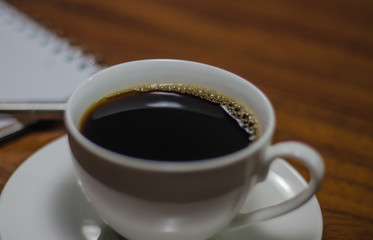 Black coffee on the wooden table