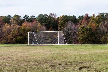 Soccer field with goal in autumn season.