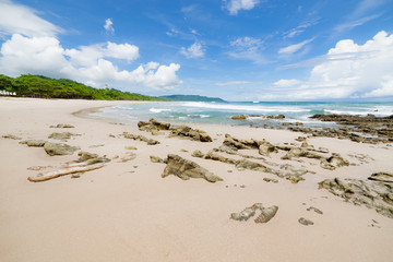 Waves sand beach and clouds sunny day