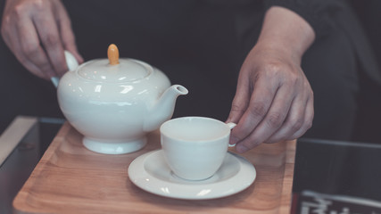 Fototapeta na wymiar Hand holding a teapot.