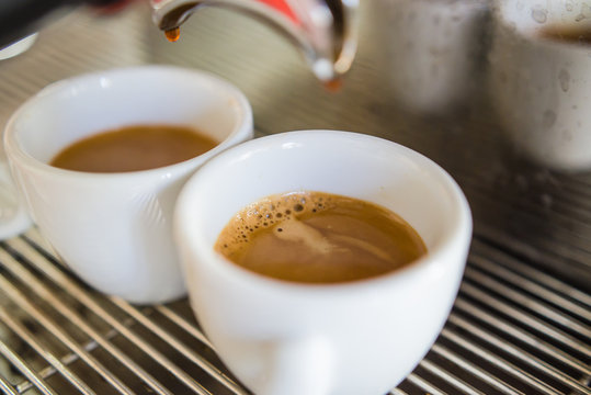 Barista making a cup of coffee soft focus image .