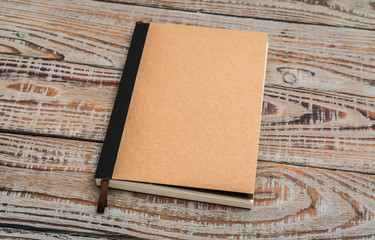 Recycled paper book on wood background .