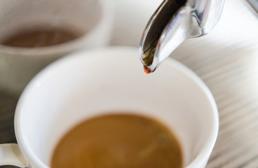 Barista making a cup of coffee soft focus image .
