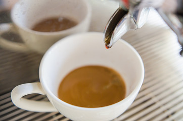 Barista making a cup of coffee soft focus image .