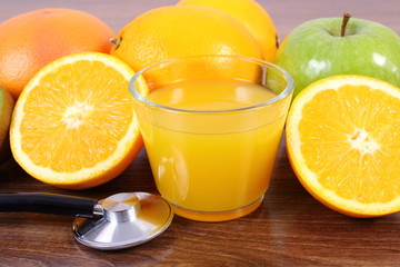 Stethoscope, fresh fruits and juice, healthy lifestyles and nutrition