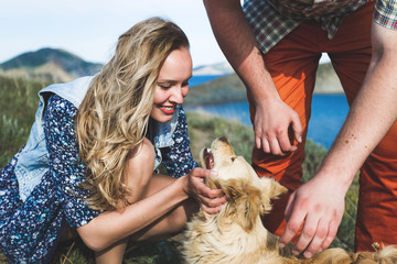 People playing with dog outside by the nature. Happy smile of girl